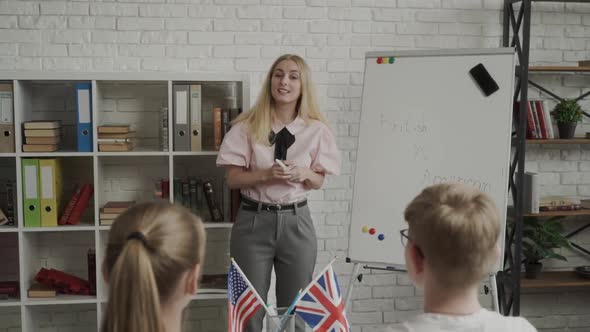 Teacher Explaining Differences Between American and British Writing on Whiteboard English Language