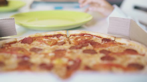 Schoolboy Takes Delicious Pizza Piece on Table Closeup