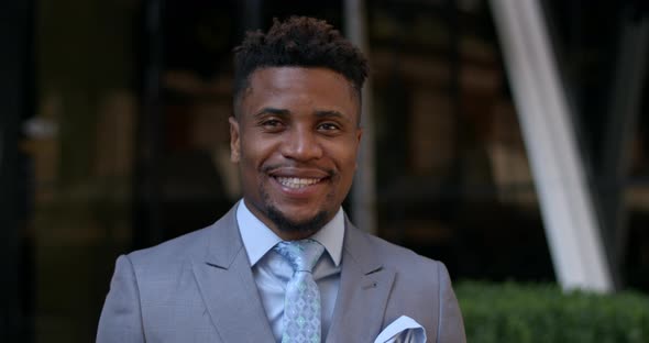 Portrait of Cheerful Afro American Man Wearing Classical Tailored Suit and Tie and Looking To Camera