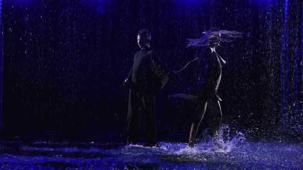 Ballroom Dancers Dancing Passionate Latin American Bachata Dance in Pouring Rain