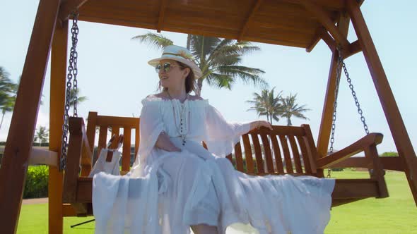 Slow Motion Attractive Dreamy Woman in White Dress Swinging Sunshine Backlight