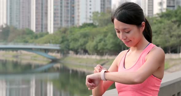 Sport woman check on smart watch at outdoor