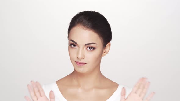 Studio portrait of young and beautiful brunette woman over