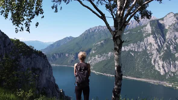 Female hiker standing at viewpoint, Lake Como, Lombardy, Italy