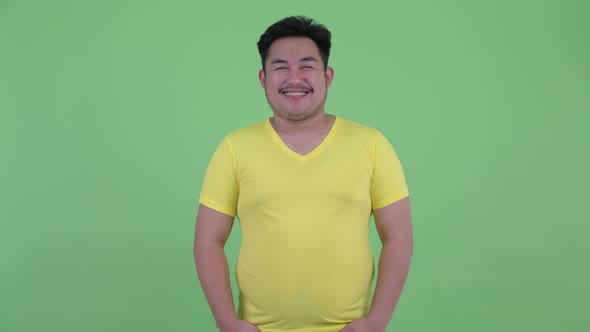 Happy Young Overweight Asian Man Smiling