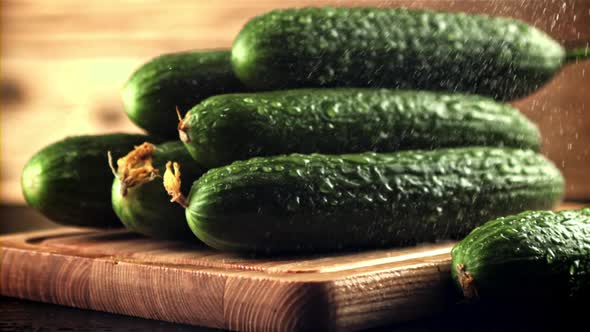 Drops of Water Fall on the Cucumbers on the Cutting Board