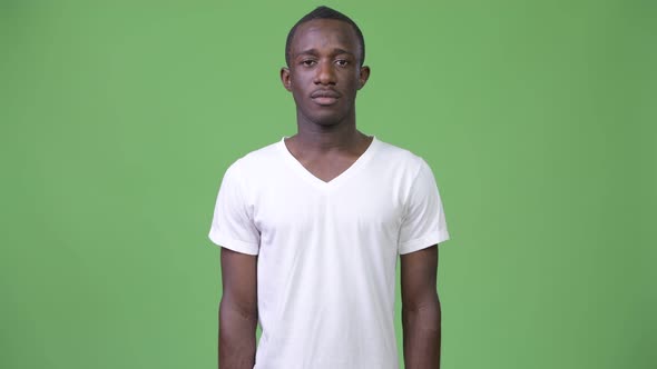 Young African Man Against Green Background