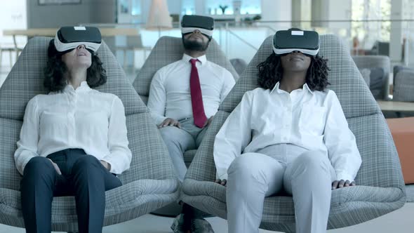 Relaxed Business Team in Vr Headsets