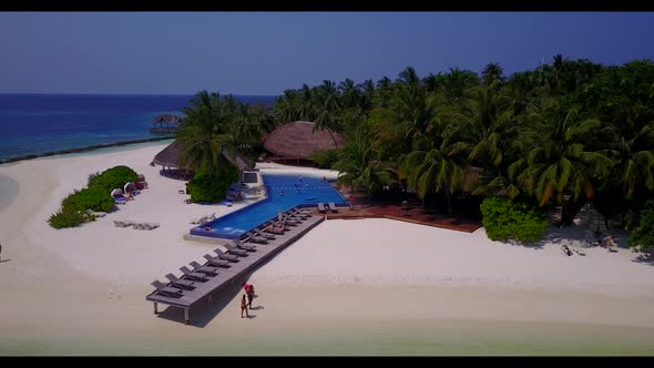 Aerial flying over tourism of perfect coast beach trip by turquoise sea with white sand background o