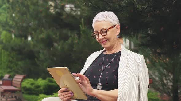 Pleasant Modern Lady Doing Online Shopping Outdoors