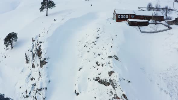 Aerial View of a Snowboard Going Uphill Near the Village at Sunset