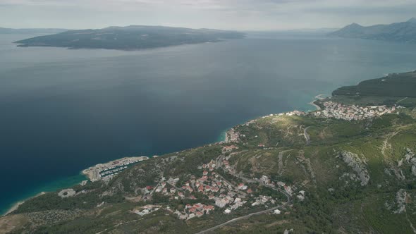 A Drone View of a Mountain Road and a Small Coastal Town in the Makarska Riviera Region of Croatia