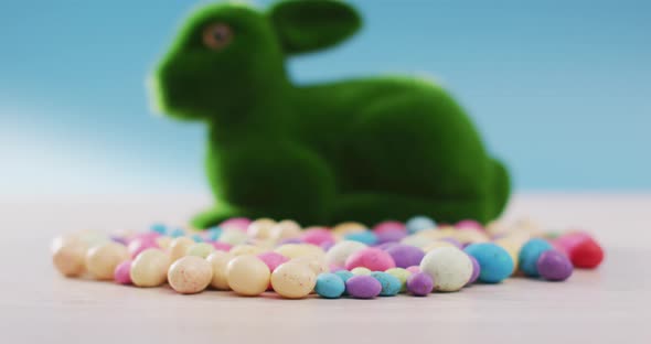 Video of decorated colorful easter eggs with bunny on a wooden surface