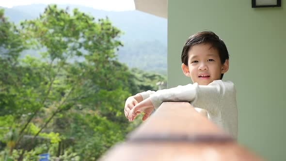 Cute Asian Child Playing At Balcony