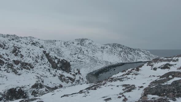 View From the Cliff to the Dragon Eggs Beach on the Shores of the Barents Sea Surrounded By Snowy