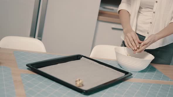 Woman Puts on Baking Tray Raw Cookies Before Baking