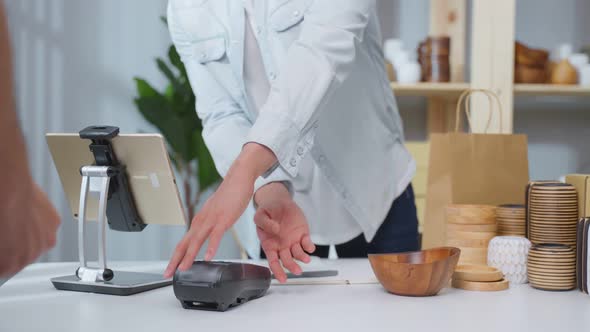 Close up hands of young man use credit card pay for vase goods order