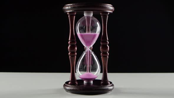 Countdown in the Hourglass. Pink Sand. Black