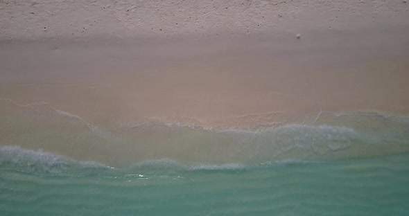 Daytime drone island view of a white sand paradise beach and turquoise sea background in 4K