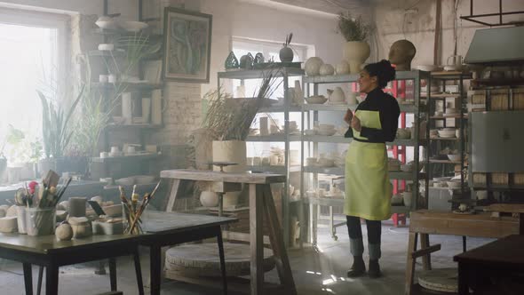 Young Woman Is Dancing Alone In Pottery Studio