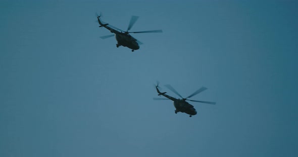 Two Helicopters Flying High in the Sky at Night