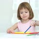 Portrait of Little Child Girl Draws with Pencils Sitting at Table at Home - VideoHive Item for Sale