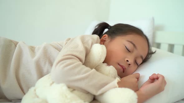 Asian Preschooler Sleeping on Bed at Home