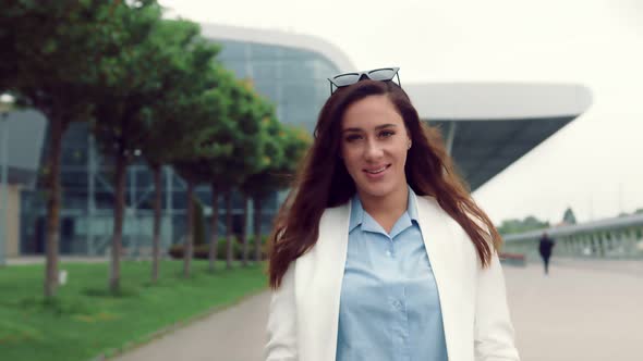 Portrait of a Pretty Caucasian Woman Walking with Smiling and Looking at the Camera. Girl on the