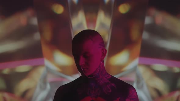 Tattooed Man Posing on Kaleidoscopic Background