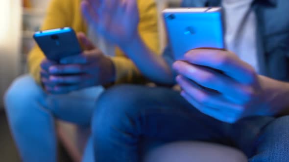 Nervous Teenagers Scrolling Old Models Smartphones, Slow Internet Connection