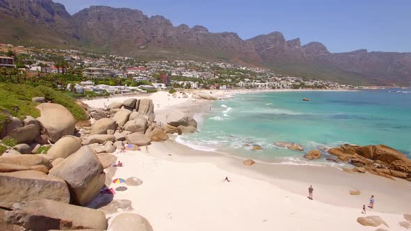 Aerial travel drone view of Camps Bay beach, Cape Town, South Africa.