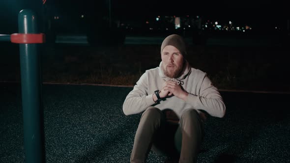 Handsome Man Is Work Out Outdoors in Night, Rising Corpus From Ground