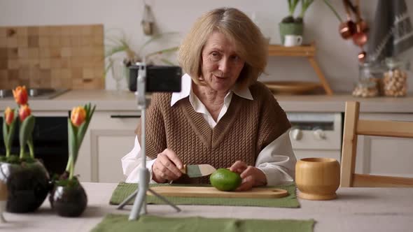 An Elderly Female Food Blogger Showing Ingredients and Explaining an Avocado Recipe on Her Phone