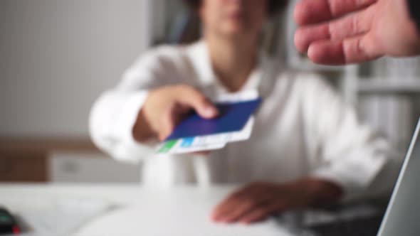 A Boarding Pass For An Airplane Is Held Out By A Travel Agent Girl. Air Tickets With A Passport