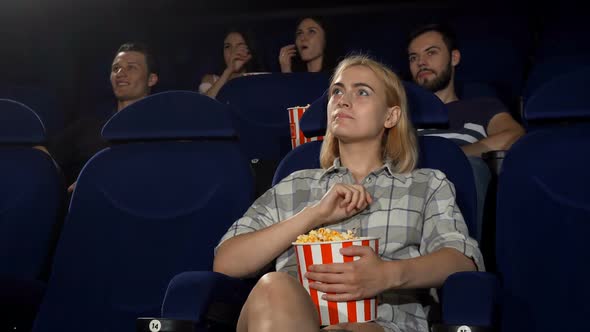 Young Attractive Woman Smiling Showing Thumbs Up at the Cinema