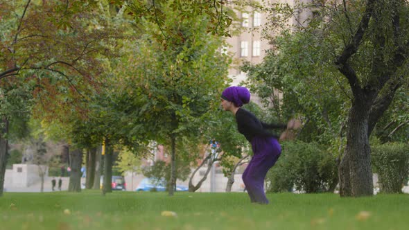 Strong Active Woman in Hijab Sporty Dancer Yoga Trainer Athlete in Park Outdoors Flying Jumping Into