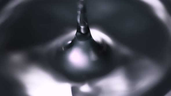 Super Slow Motion Shot of Water Drop Falling Into Water Surface at 1000 Fps