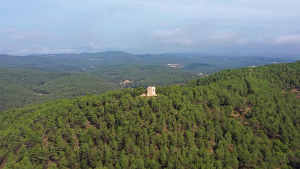 Epic Drone circle Aerial and approach of a Medieval Historic Hill Top Observation Tower surrounded b