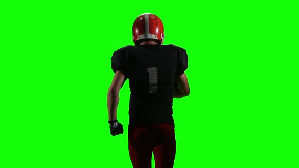 Athlete Touches the Ball in His Hands and Running. Green Screen, Back View,