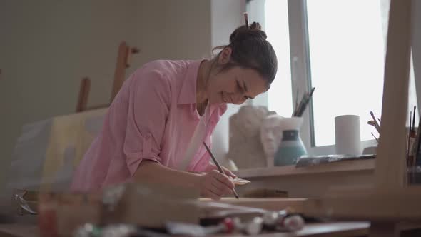 Female Artist Working in Studio