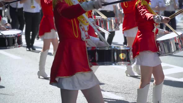 Young Girls Drummer in Red at the Parade. Street Performance on the Occasion of the Holiday