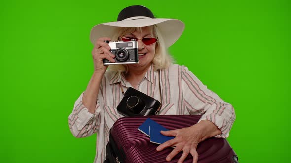 Senior Woman Tourist Photographer Taking Photos on Retro Camera and Smiling on Chroma Key Background