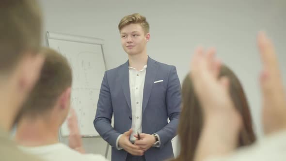 Portrait Handsome Successful Businessman Presenting New Project To Partners with Flip Chart