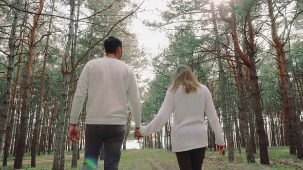 Man and Woman Walking in Forest