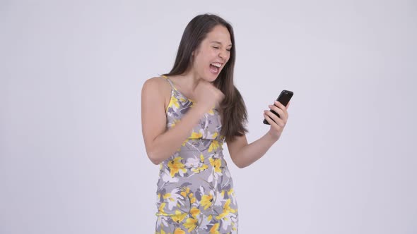 Young Happy Multi-ethnic Tourist Woman Using Phone and Getting Good News