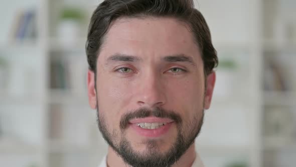 Close Up of Happy Young Man Looking at the Camera