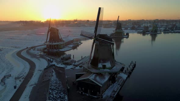 Wooden Wind Mill at the Zaanse Schans Windmill Village During Winter with Snowy Landscape Snow