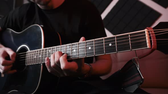 Young Man Playing Acoustic Guitar While Sitting Sofa Home Recording Studio