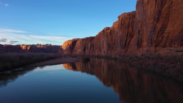 Colorado River and Red Sandstone Cliffs on Sunny Day