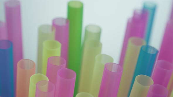 Cocktail Multicolored Plastic Tubes on a Dark Background Camera Motion